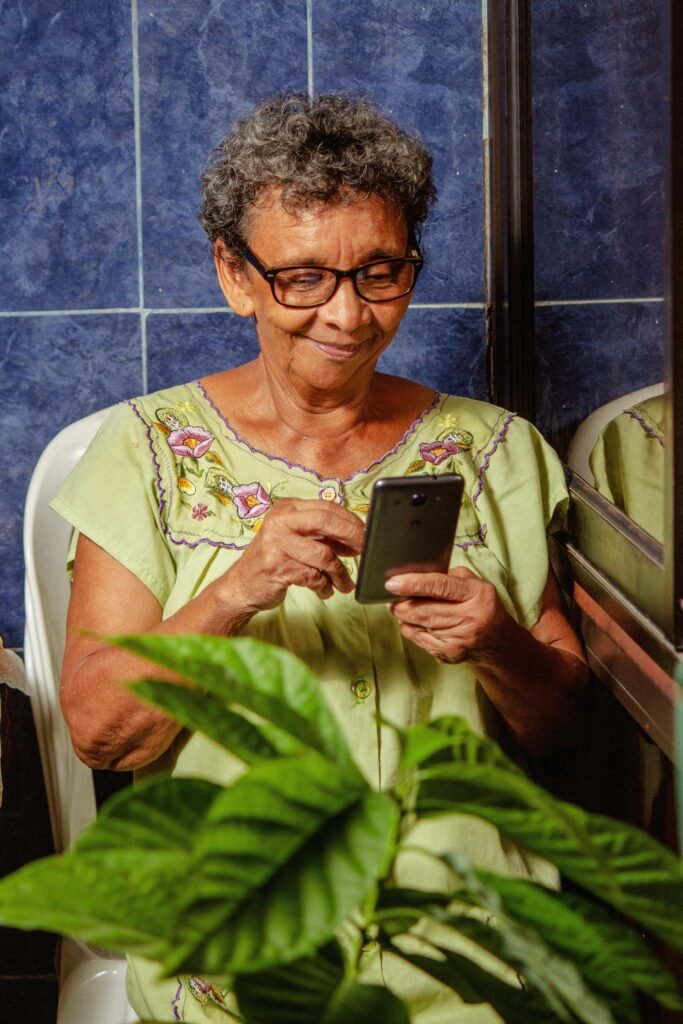 65 plus year old senior using a smart phone