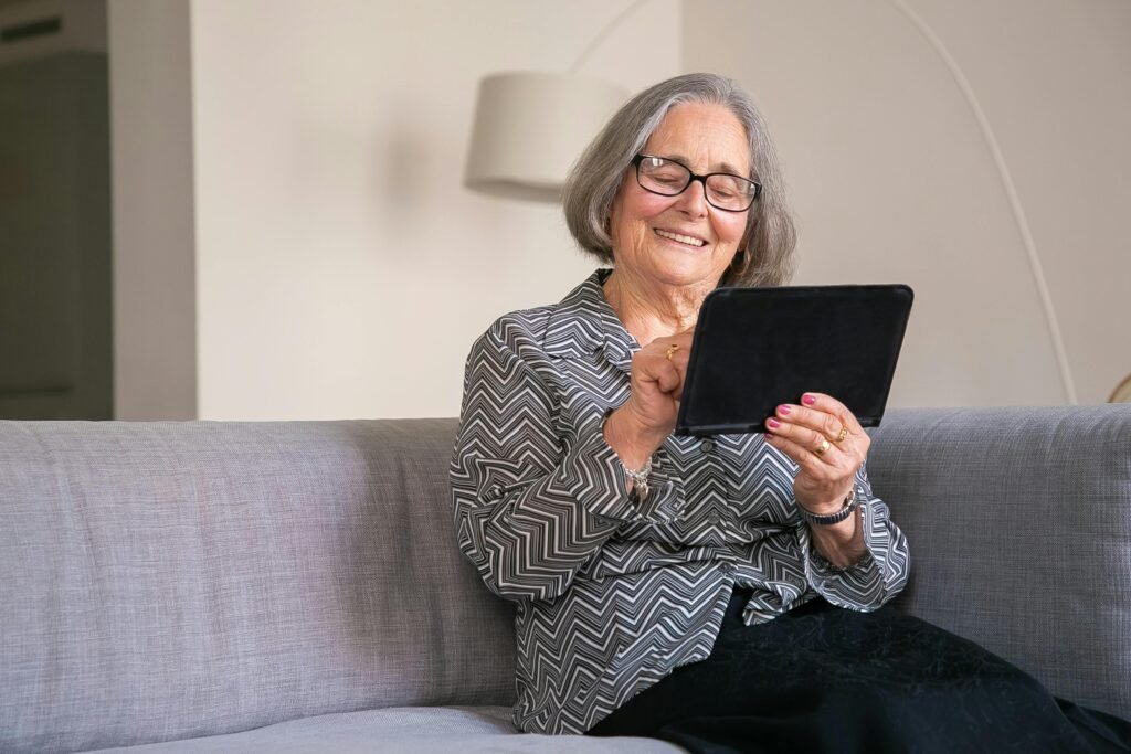 An elderly woman using her tablet